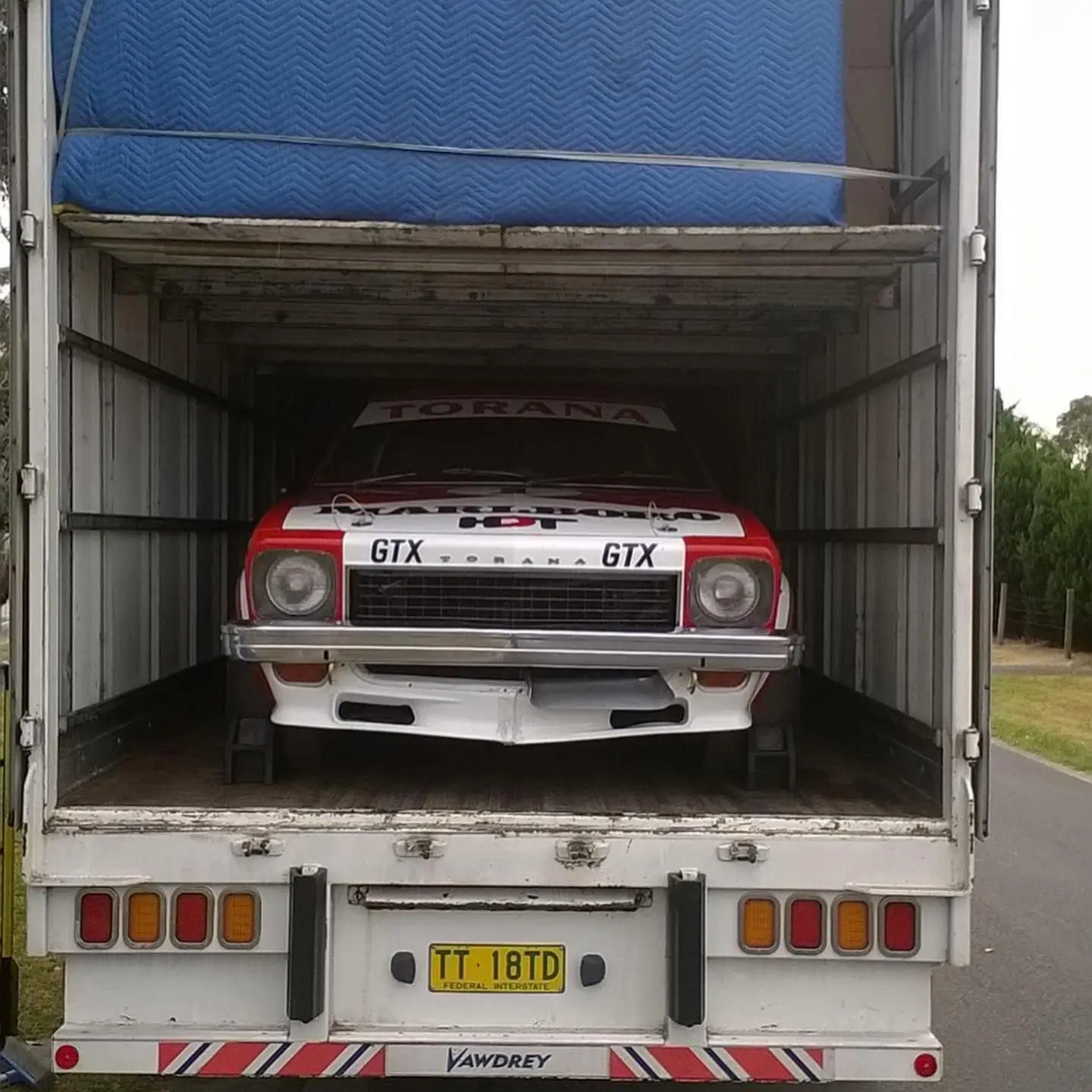 Classic car being transported in a truck