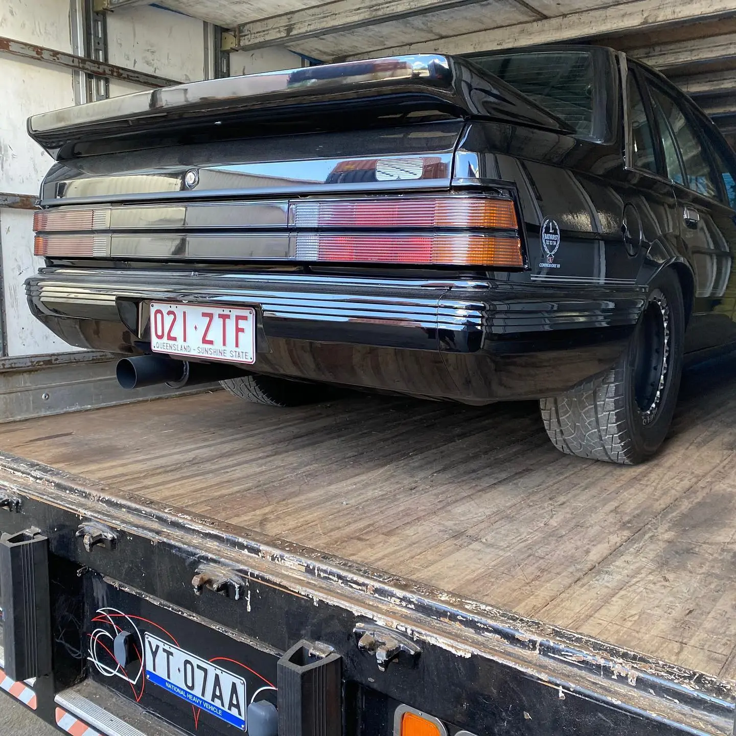 Black sedan prepared for long-distance vehicle transport