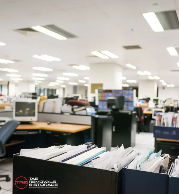 Office relocation in Tasmania with labelled crates, packed workstations and organised loading for a low-downtime business move